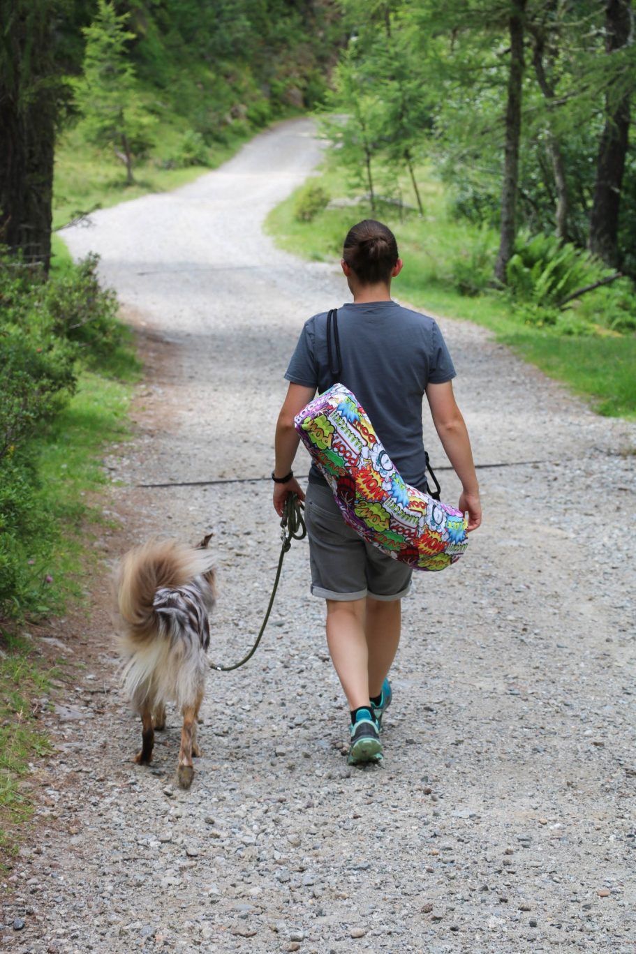 Geschenkidee Hund und Frauchen mit Deckentasche laufen einen Weg entlang